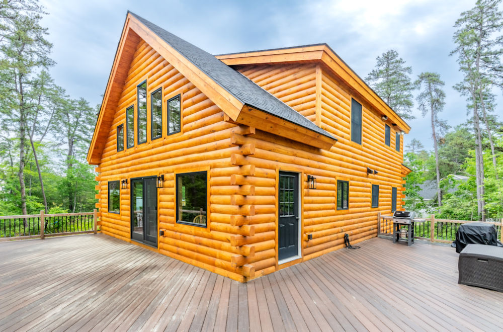 New log home construction with deck.